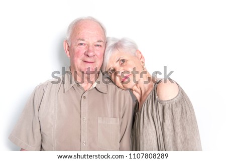Senior couple posing on studio white background