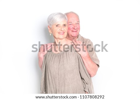 Senior couple posing on studio white background