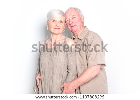 Senior couple posing on studio white background