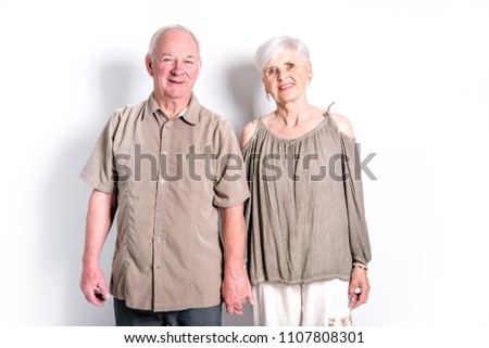 Senior couple posing on studio white background
