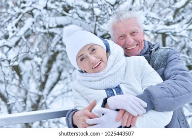 senior couple posing outdoors