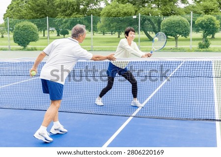 Senior couple practicing net play - Tennis lesson