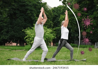 Senior couple practicing yoga outdoors. Healthy lifestyle - base of strong immunity - Powered by Shutterstock