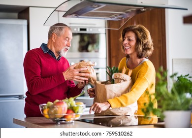 Senior couple preparing food in the kitchen. - Powered by Shutterstock