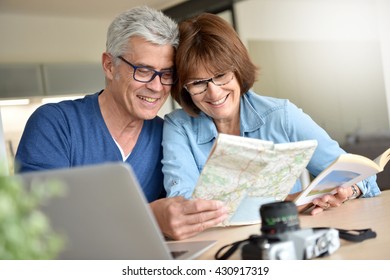 Senior Couple Preparing Vacation Trip