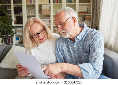Senior couple reading a retirement plan or power of attorney or living will