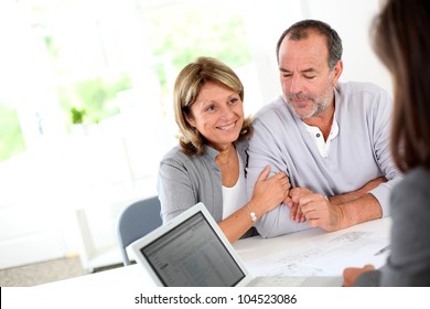 Senior couple ready to buy new house reading contract