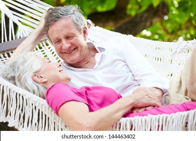 Senior Couple Relaxing In Beach Hammock - Powered by Shutterstock