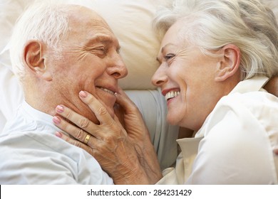 Senior Couple Relaxing In Bed