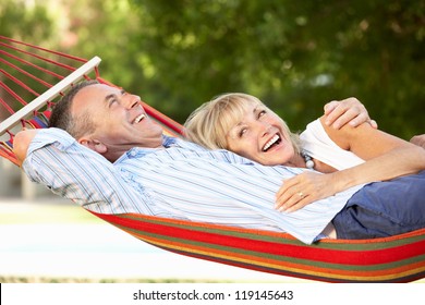 Senior Couple Relaxing In Hammock - Powered by Shutterstock