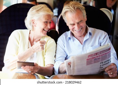 Senior Couple Relaxing On Train Journey - Powered by Shutterstock