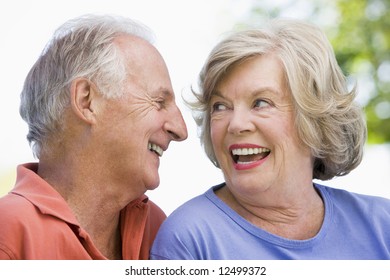 Senior Couple Relaxing Outside In Park