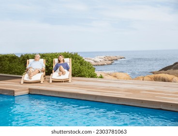 Senior couple relaxing at poolside - Powered by Shutterstock