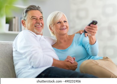 Senior couple with remote control
