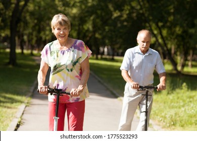 senior couple riding a scooters in the park. Active Seniors - Powered by Shutterstock