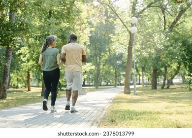 Senior couple running in the park - Powered by Shutterstock