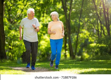 Senior Couple Running In Park
