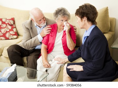 Senior couple sees a therapist to cope with grief.  Could also be funeral director meeting with clients. - Powered by Shutterstock