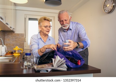 Senior couple separating recyclable trash at home - Powered by Shutterstock