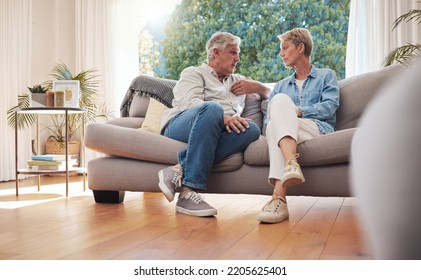 Senior couple, serious talk and communication about problems and marriage issues while sitting on the sofa at home. Mature man and woman talking and discussing issues, trouble and divorce - Powered by Shutterstock