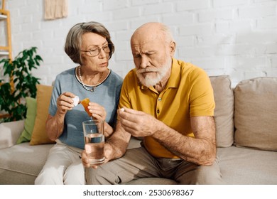 A senior couple shares a moment as the wife helps her husband manage his diabetes treatment. - Powered by Shutterstock