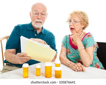 Senior Couple Shocked By The High Cost Of Their Medical Bills.  White Background.