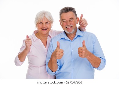 Senior couple showing thumbs up
