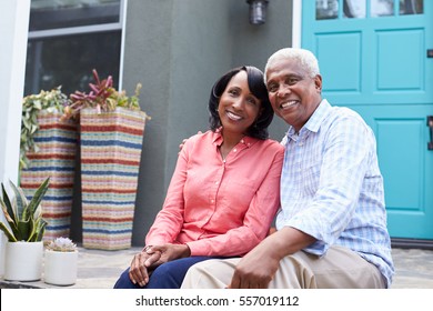 Senior Couple Sit On Steps Outside Their House, Close Up