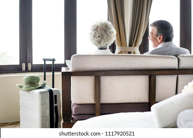 Senior Couple Sitting In A Hotel Room