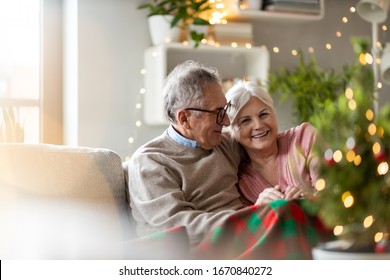 Senior couple sitting in the living room together during Christmas
 - Powered by Shutterstock