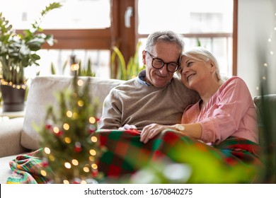 Senior couple sitting in the living room together during Christmas
 - Powered by Shutterstock