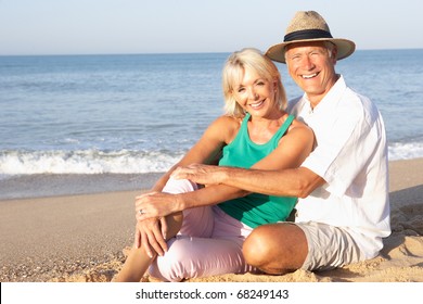 Senior Couple Sitting On Beach Relaxing