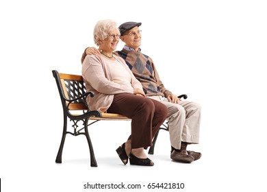 Senior Couple Sitting On A Bench And Looking Away Isolated On White Background