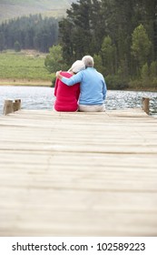 Senior Couple Sitting On A Jetty