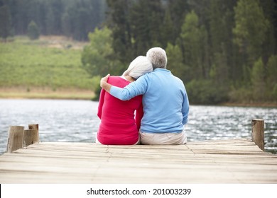 Senior Couple Sitting On A Jetty