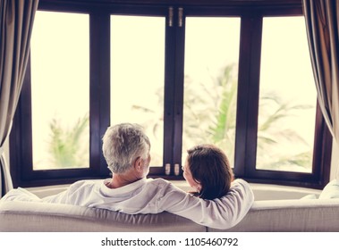 A Senior Couple Sitting On A Sofa