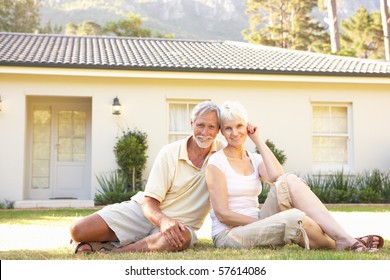 Senior Couple Sitting Outside Dream Home