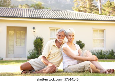 Senior Couple Sitting Outside Dream Home