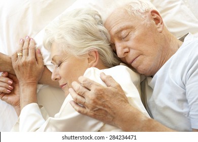 Senior Couple Sleeping In Bed - Powered by Shutterstock