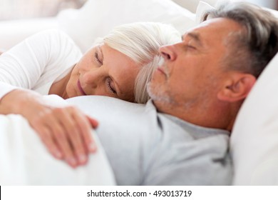 Senior Couple Sleeping In Bed
