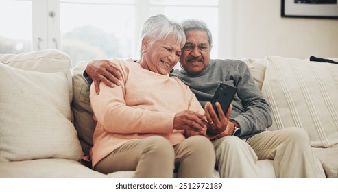 Senior couple, smartphone and happy on sofa with hug, reading and notification with funny story in home. Woman, man and phone in retirement, relax and embrace with comic memory on mobile app in house - Powered by Shutterstock