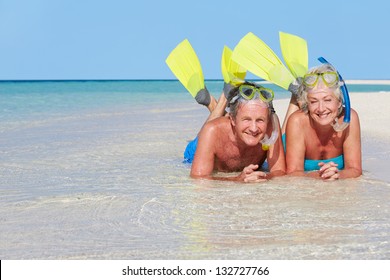 Senior Couple With Snorkels Enjoying Beach - Powered by Shutterstock