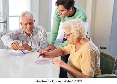 Senior couple with son solving maze puzzles as memory training against dementia - Shutterstock ID 2046706793