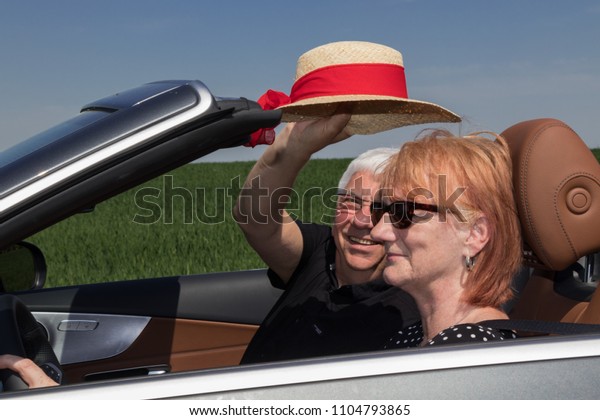 Senior couple in sports\
car