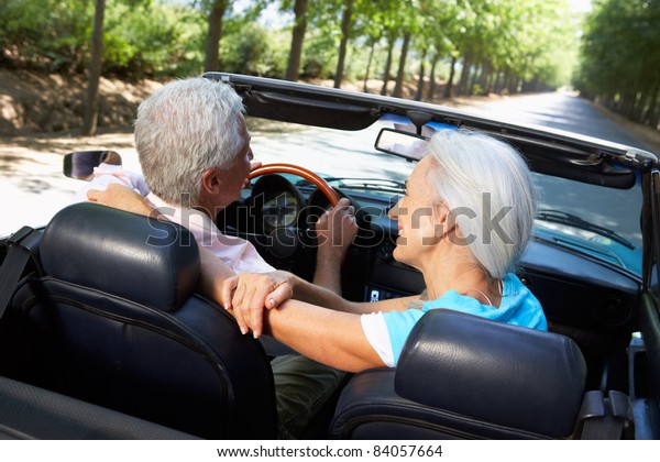 Senior couple in sports\
car