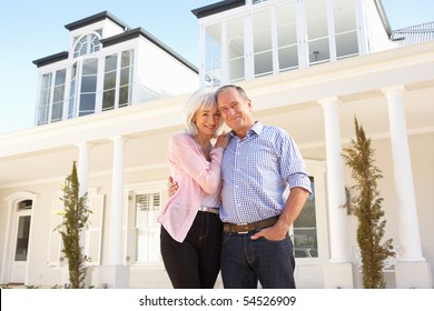 Senior Couple Standing Outside Dream Home