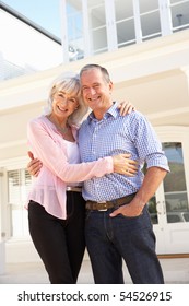 Senior Couple Standing Outside Dream Home