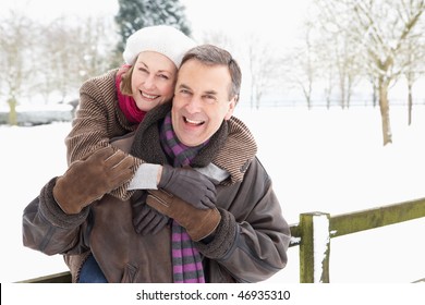 Senior Couple Standing Outside In Snowy Landscape