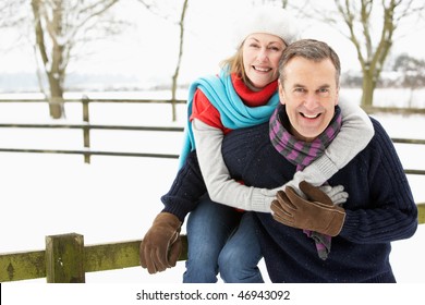 Senior Couple Standing Outside In Snowy Landscape