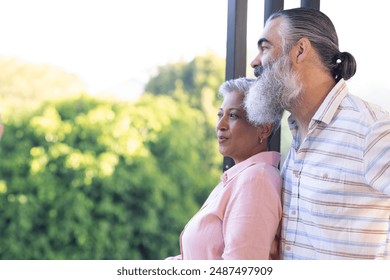 Senior couple standing together and enjoying nature view from balcony, copy space. Retirement, togetherness, outdoors, serene, landscape, elderly - Powered by Shutterstock